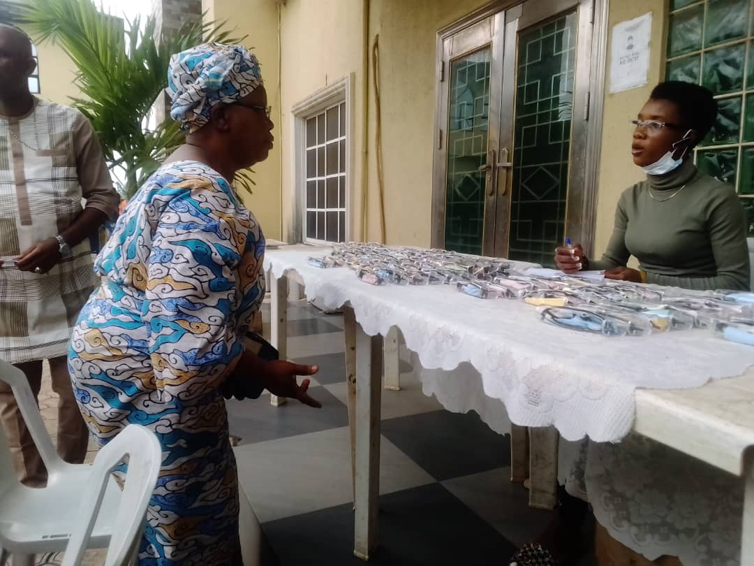 Volunteers arranging catering gift package boxes on long banquet tables